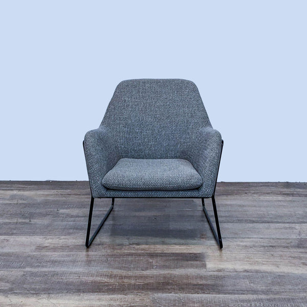 Front view of the Forma chair by Article with a curved metal frame and gray upholstery.