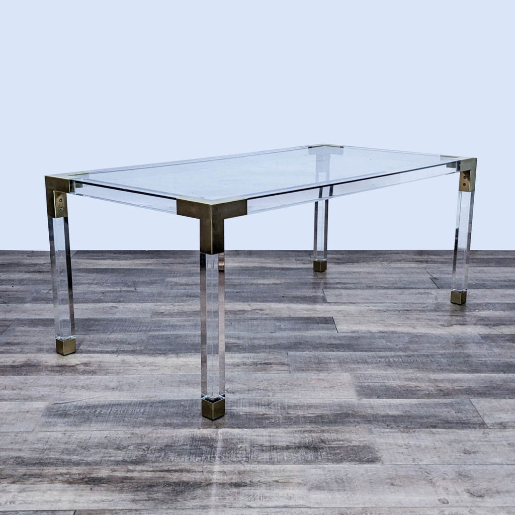 3. Rectangular dining table from Jonathan Adler features transparent acrylic and brass details for a glamorous look.
