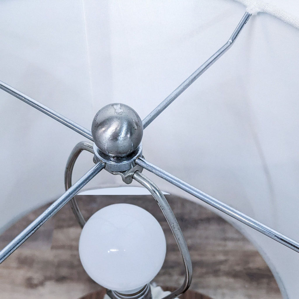 Top-down view of Reperch lamp interior, showing metal frame and bulb against the shade.