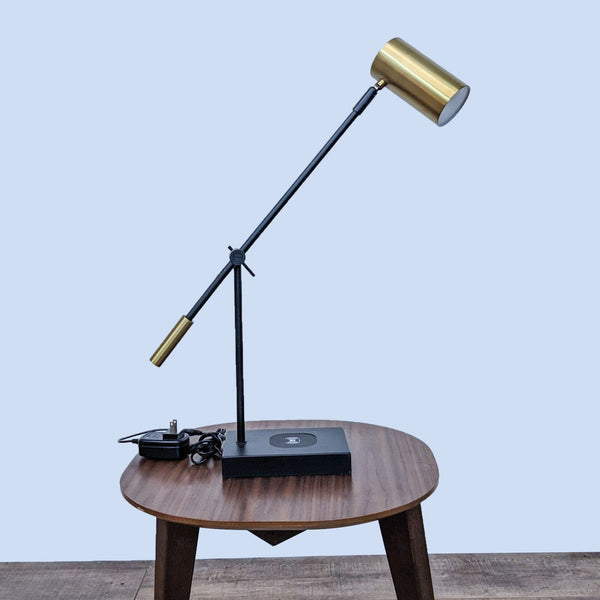 Adjustable Reperch lamp with wireless tech on a wooden table.