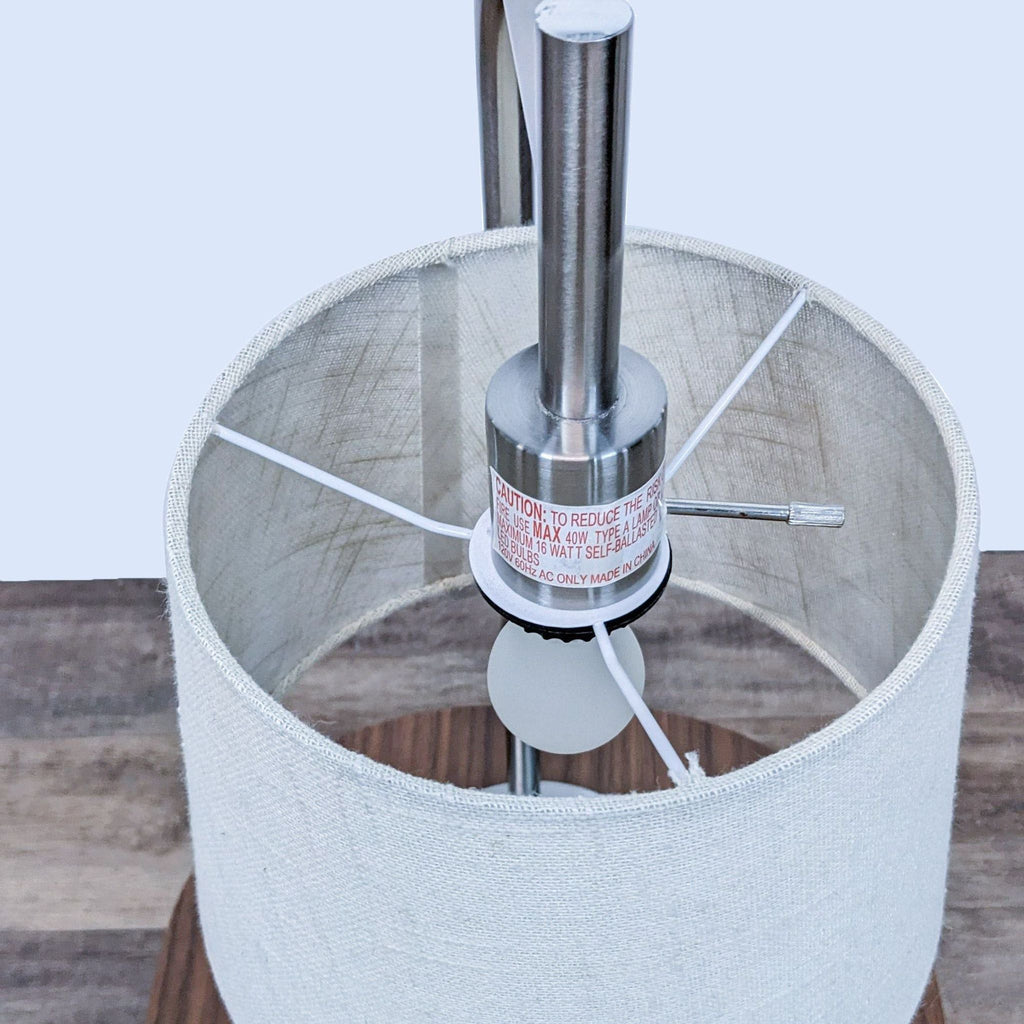 Close-up of a Reperch lamp showing the metallic fixture inside the fabric shade.