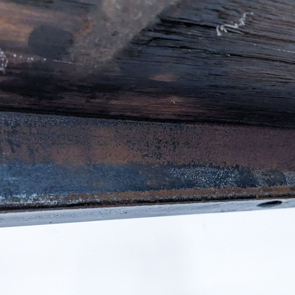 Detail of the bookshelf's durable metal frame and wood grain.