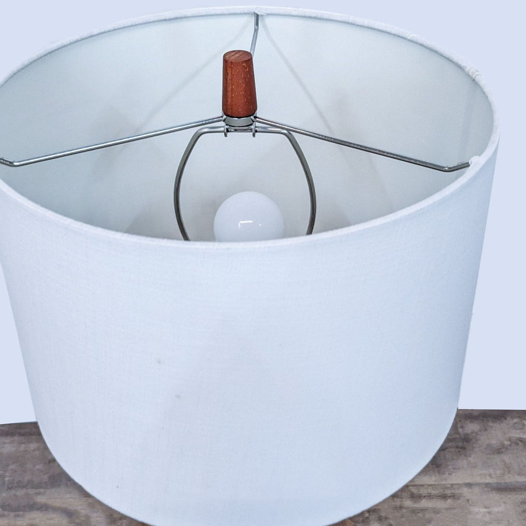 Close-up of the Reperch lamp's white shade and bulb.