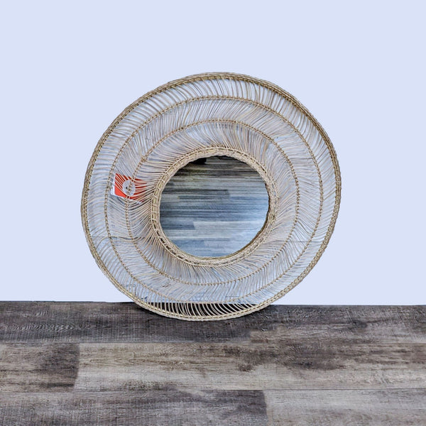 Rattan-framed round mirror with a natural woven design by Article, named Meron.