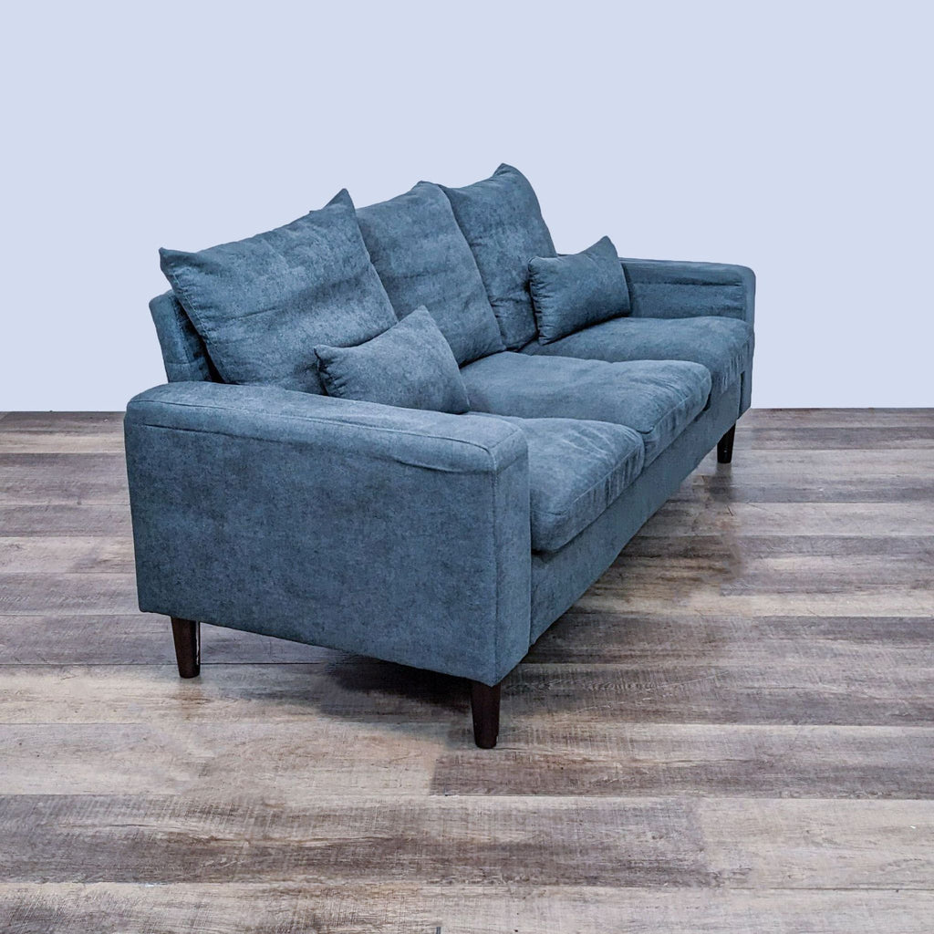 Angled view of a compact 3-seat sofa with track arms and dark finish legs.