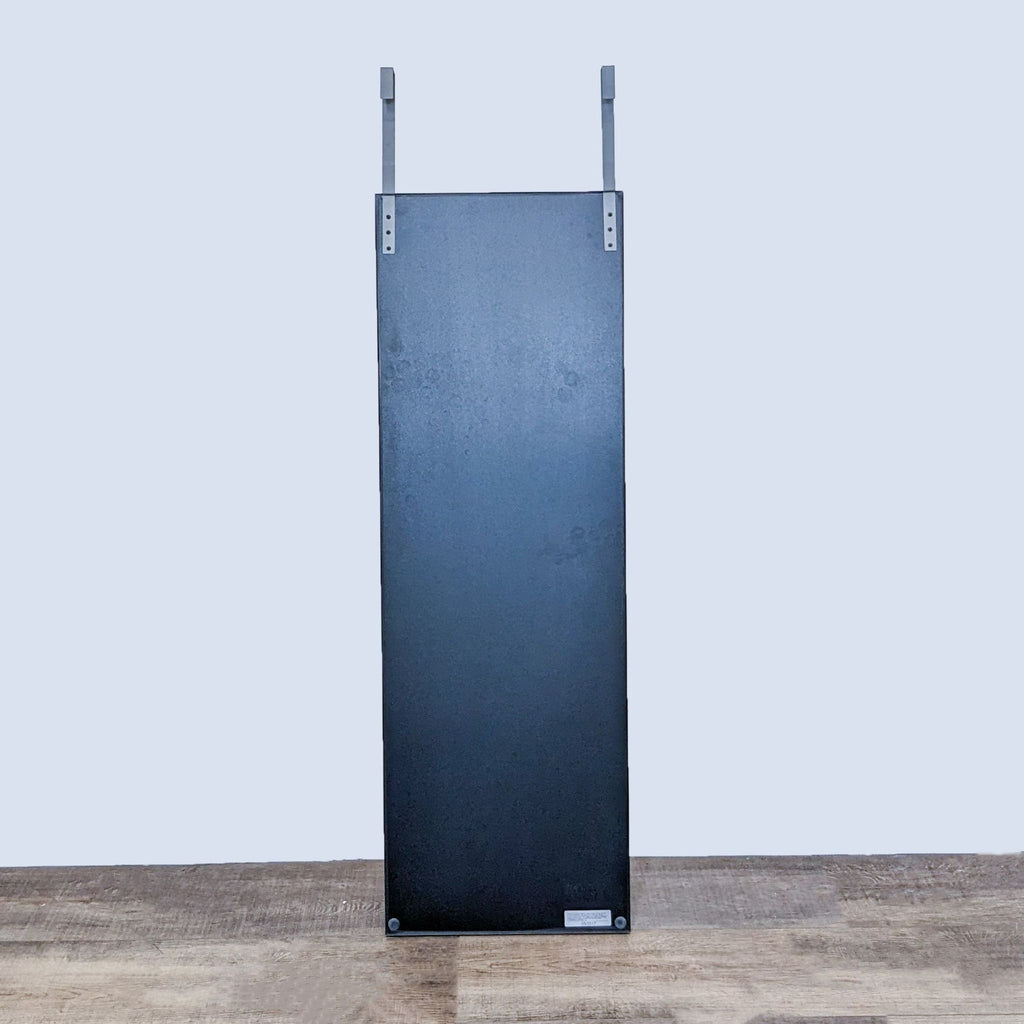 Back view of the Crate & Barrel mirror showing its sturdy metal hanger system.