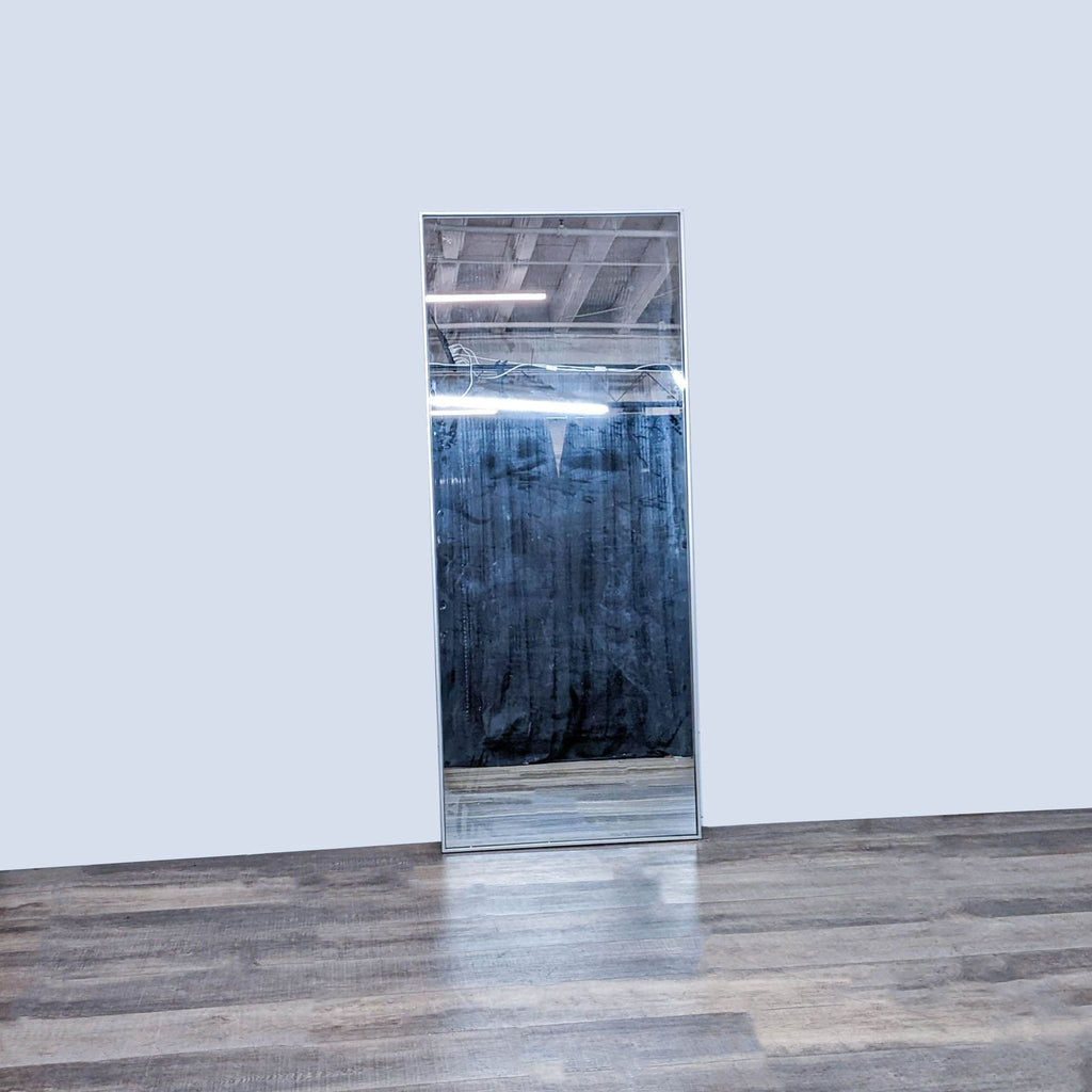 Close-up of West Elm mirror showing the slim steel frame.