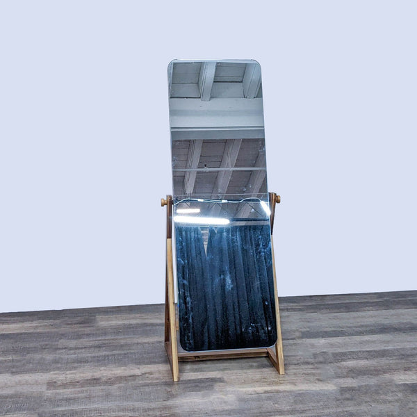 CB2 Drommen Mirror with acacia wood frame on angular platform.