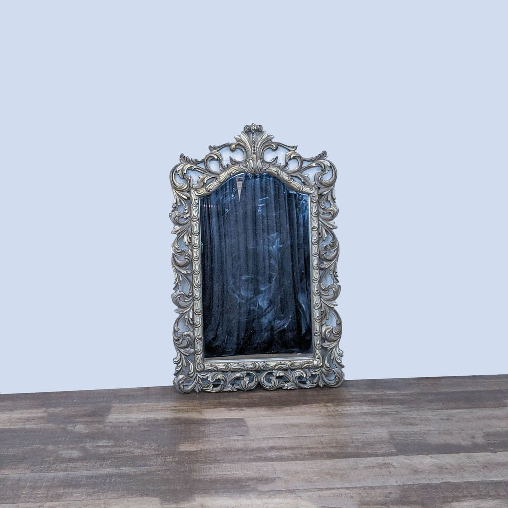 Ornate wall mirror with antique silver and gold accents, by Pacific Coast Lighting.