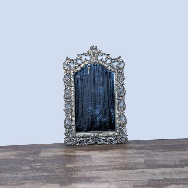 Ornate wall mirror with antique silver and gold accents, by Pacific Coast Lighting.