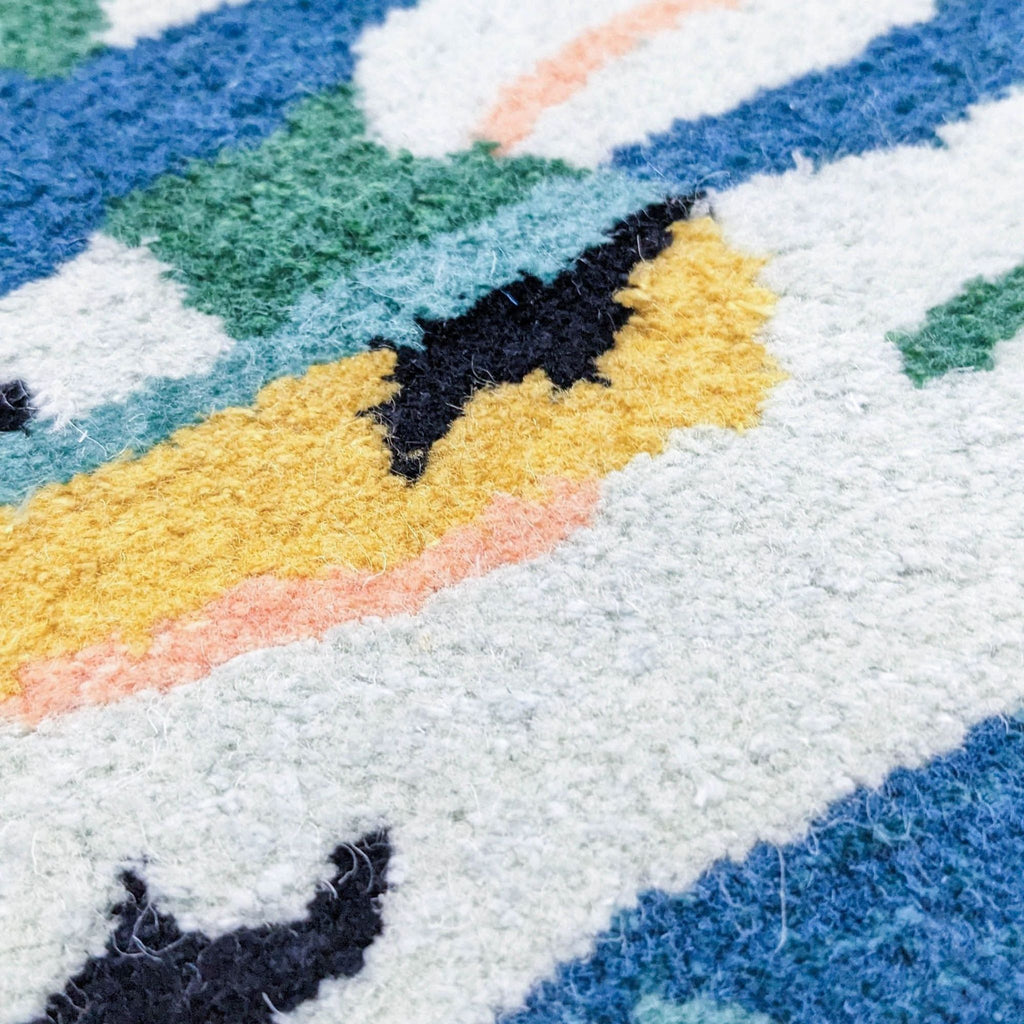 Detailed view of the CB2 Midnight Jungle rug's wool and rayon weave in vibrant colors.