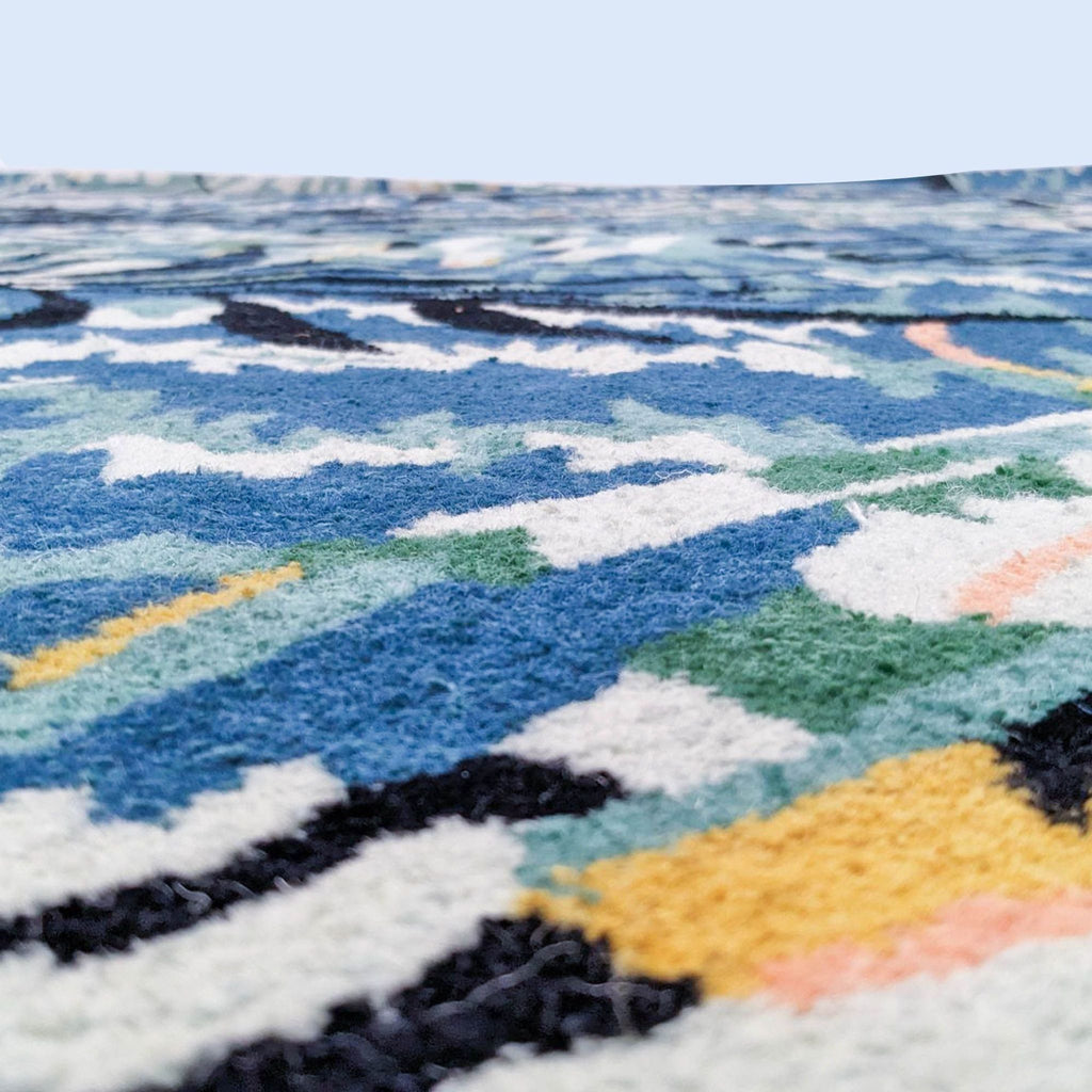 Close-up of the CB2 Midnight Jungle rug showing high pile texture in colorful leaf design.