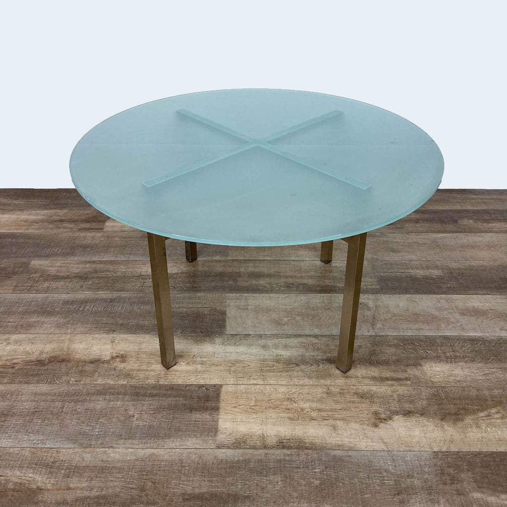Room & Board dining table with gold finish base and frosted glass top.