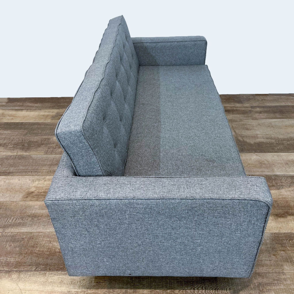 Compact gray sofa with clean lines and a minimalist design.