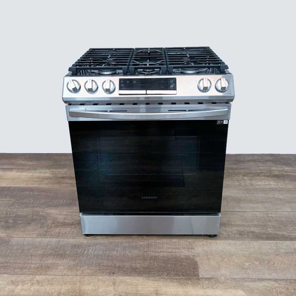 Samsung stove with a black and stainless steel design, gas burners on top.