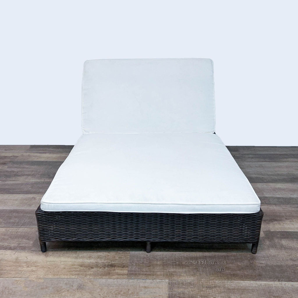 Front view of adjustable wicker double chaise with white cushion.