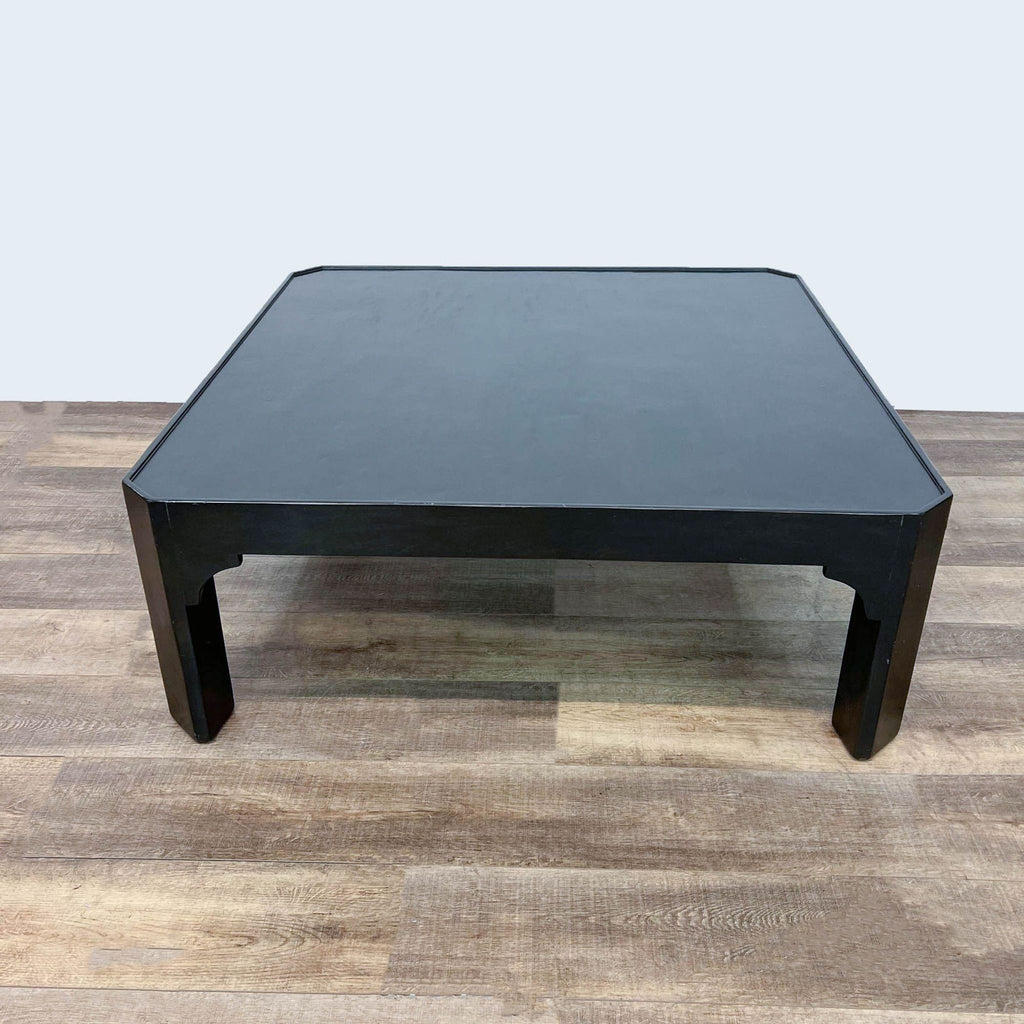 Classic black square coffee table by Dennis & Leen, displayed on textured wooden floor.