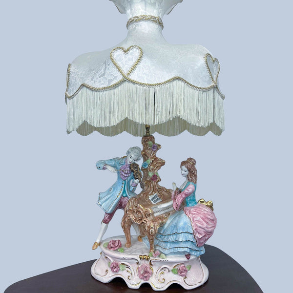 Elegant lamp by Reperch with musicians and a heart-trimmed shade.  