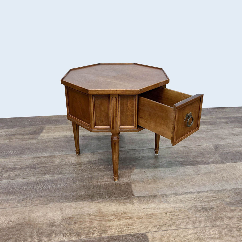 Wooden end table by Reperch, octagonal shape, drawer open, detailed carved legs.