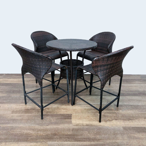 Woven resin wicker table set with four matching chairs on metal frames.