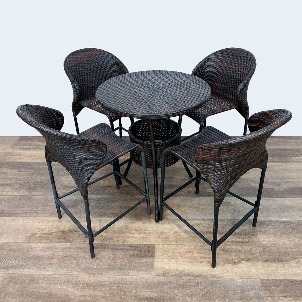 Round table with four matching resin wicker chairs and metal frames.