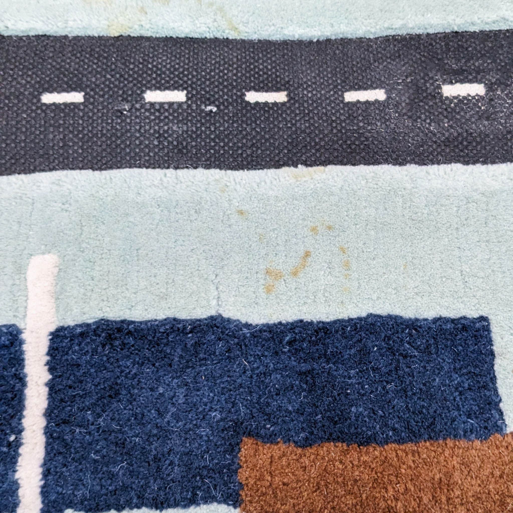 Detailed view of City Car rug showing roads and colorful patterns.