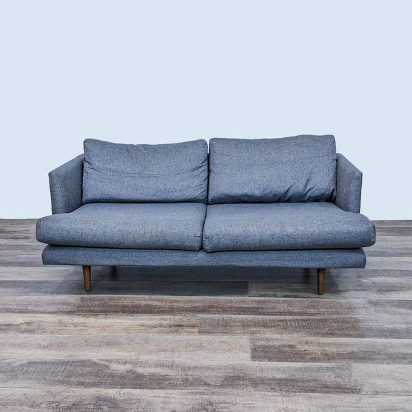 Mid-century graphite gray loveseat with narrow arms and wooden tapered feet.