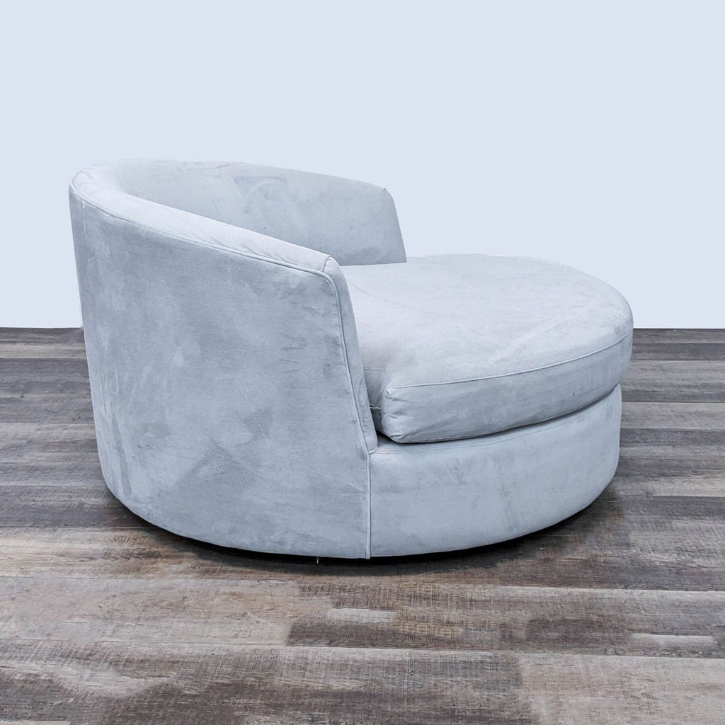 Elegant gray lounge chair by Crate and Barrel, featuring wide seating and a swivel base.