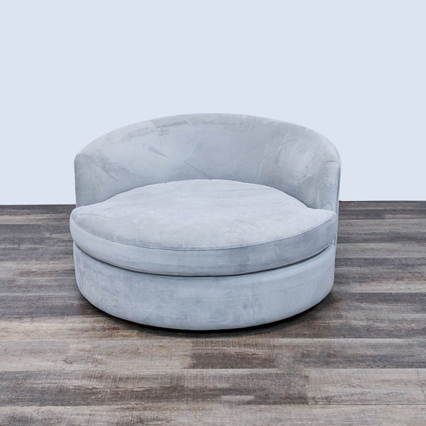 Contemporary barrel-back lounge chair with a swivel base from Crate and Barrel.