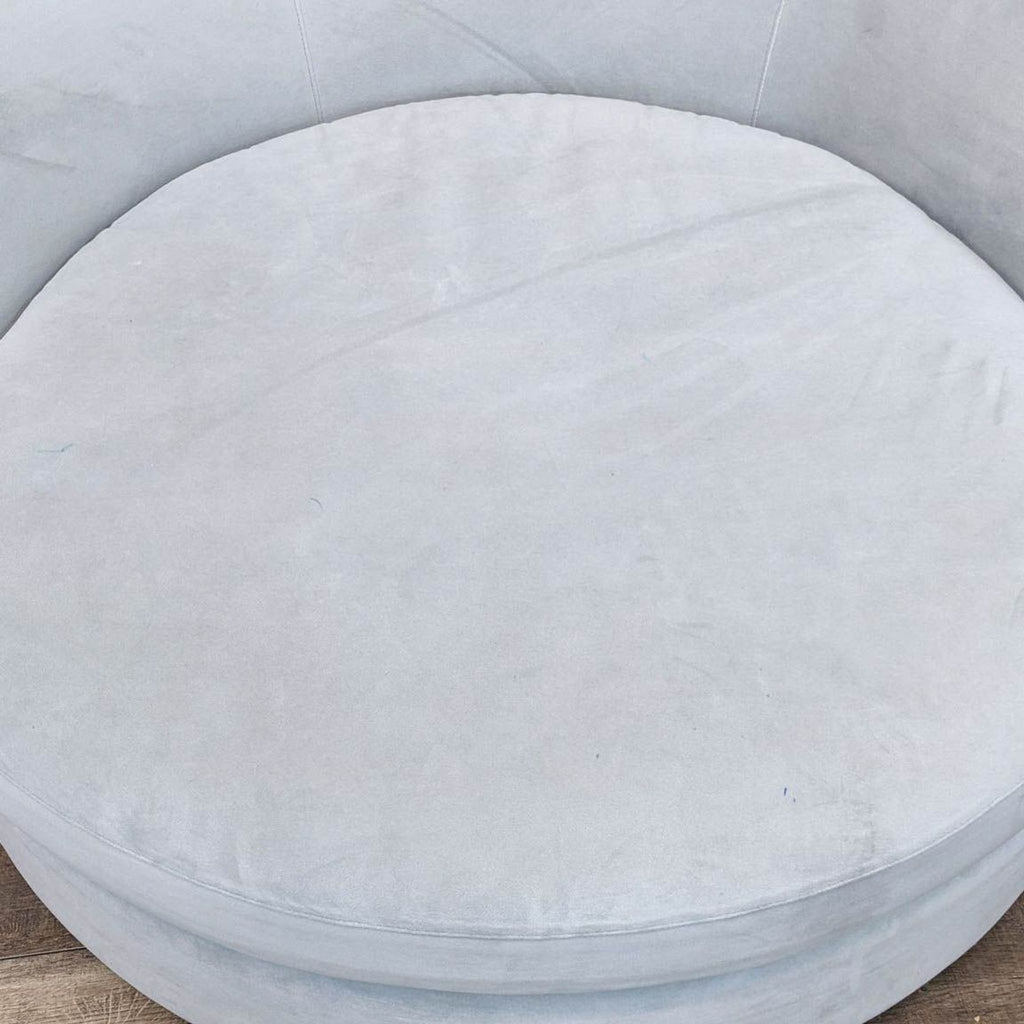Close-up of a smooth, round cushion from the Tillie Grande chair by Crate and Barrel.