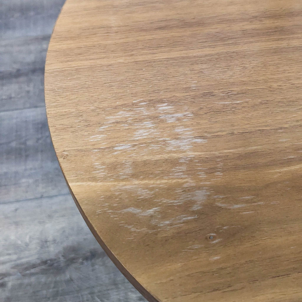2. Close-up of wooden tabletop with visible surface wear and white marks, part of a Reperch lamp-table.  