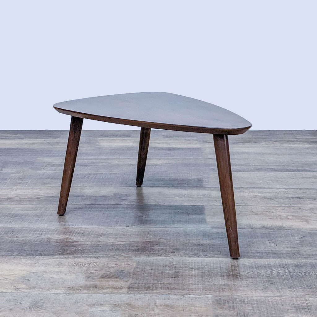 Stylish triangular Zuo Modern coffee table with a dark wooden finish and minimalist design.