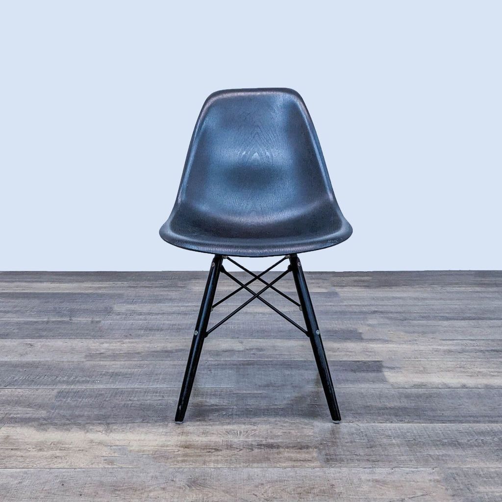 Reperch dining chair with black contoured plastic seat and Eiffel-style metal base.  