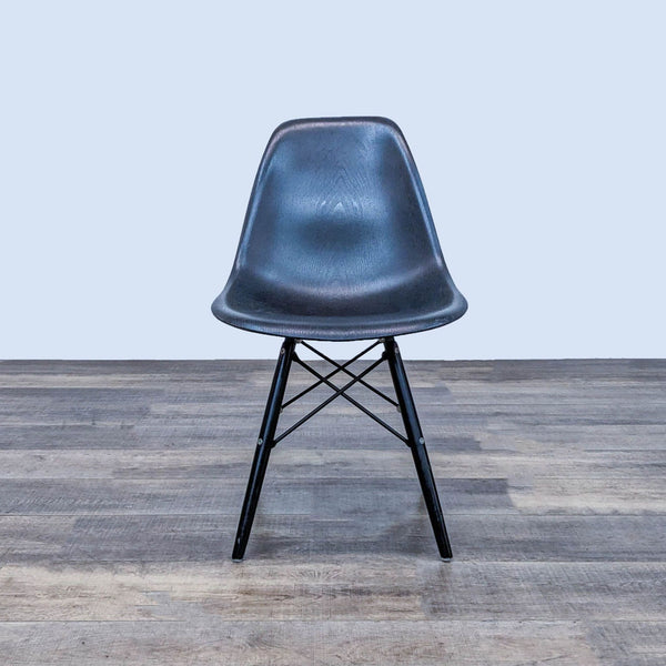 Reperch dining chair with black contoured plastic seat and Eiffel-style metal base.  