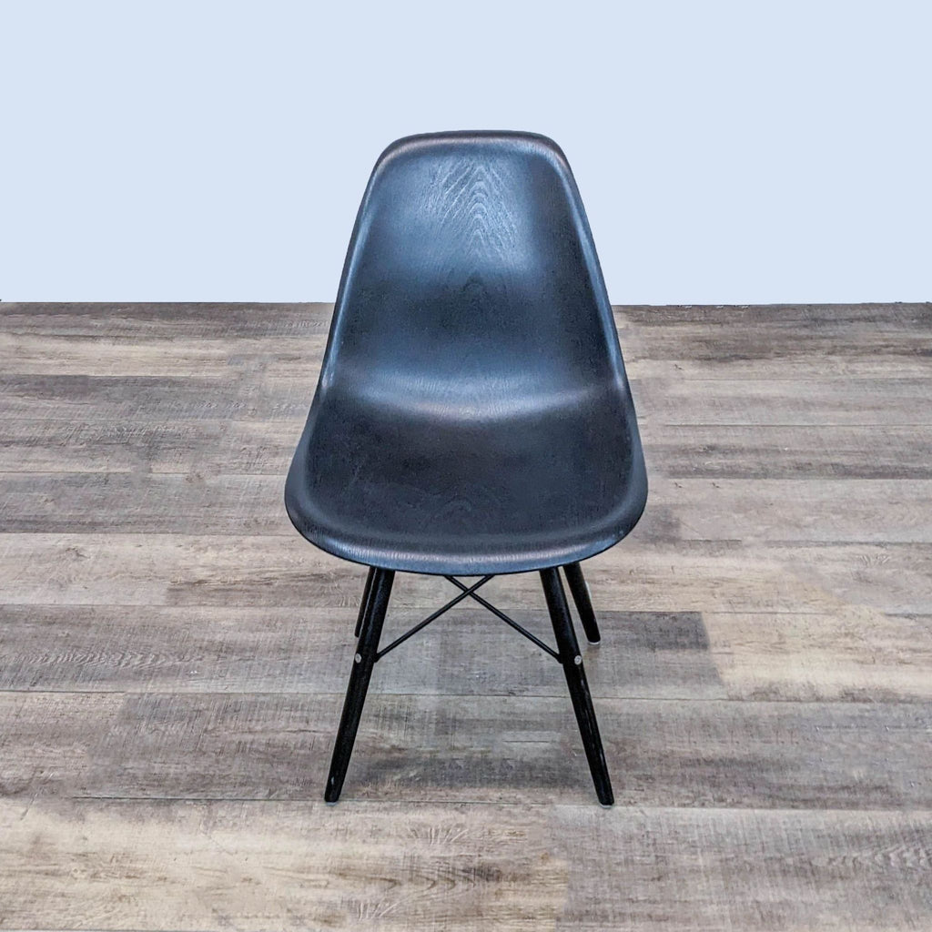 Front view of black Reperch dining chair with wood grain texture and metal base.  