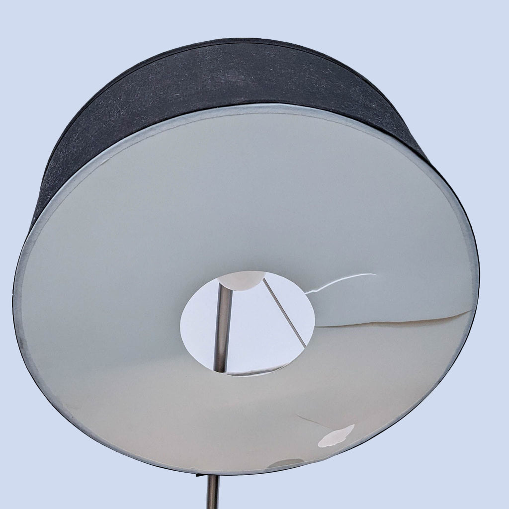 Close-up view of the Reperch lamp's round black shade.