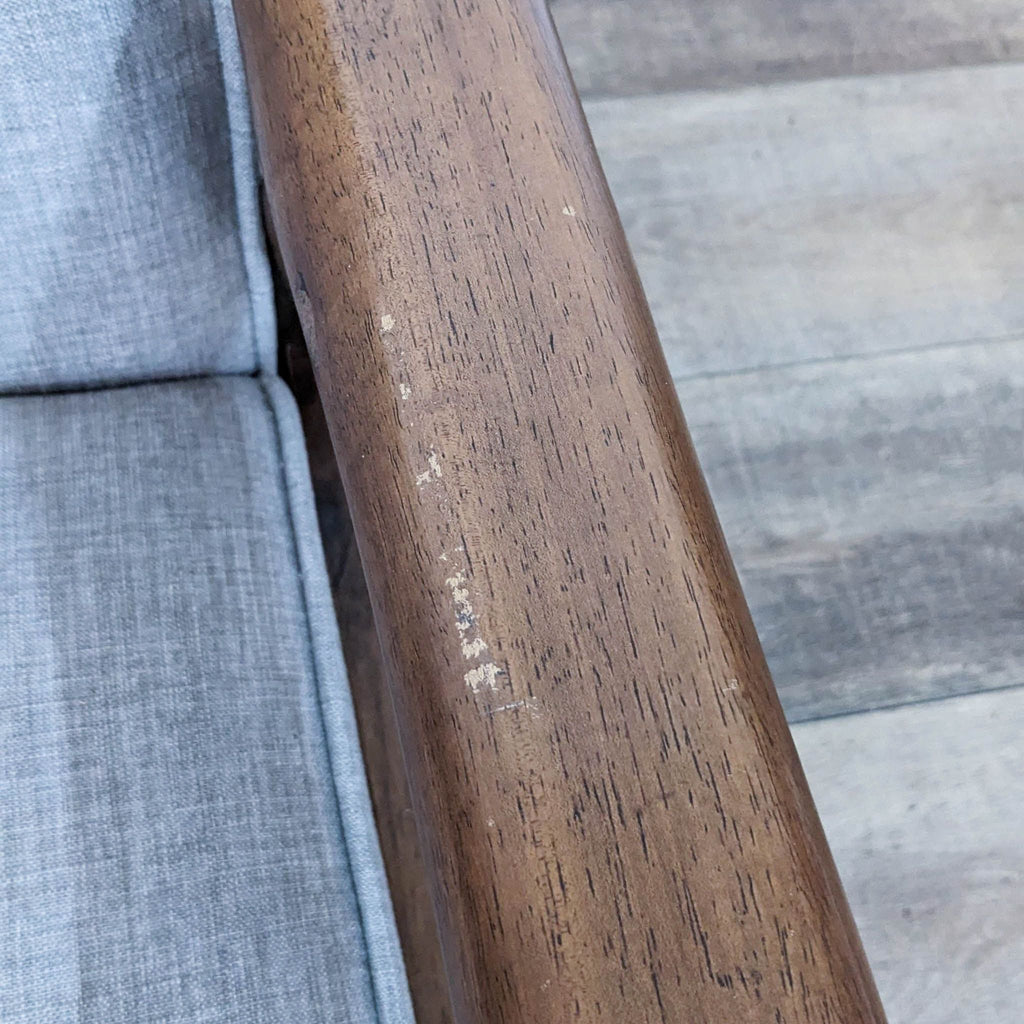 Close-up of Rocky Armchair armrest, highlighting walnut finish and textured cushion detail by Zuo Modern.