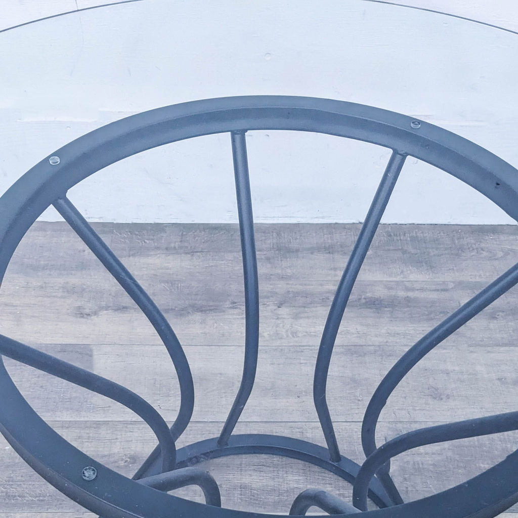 Stylish Zurich table by Armen Living showcases a unique black metal base with glass top.