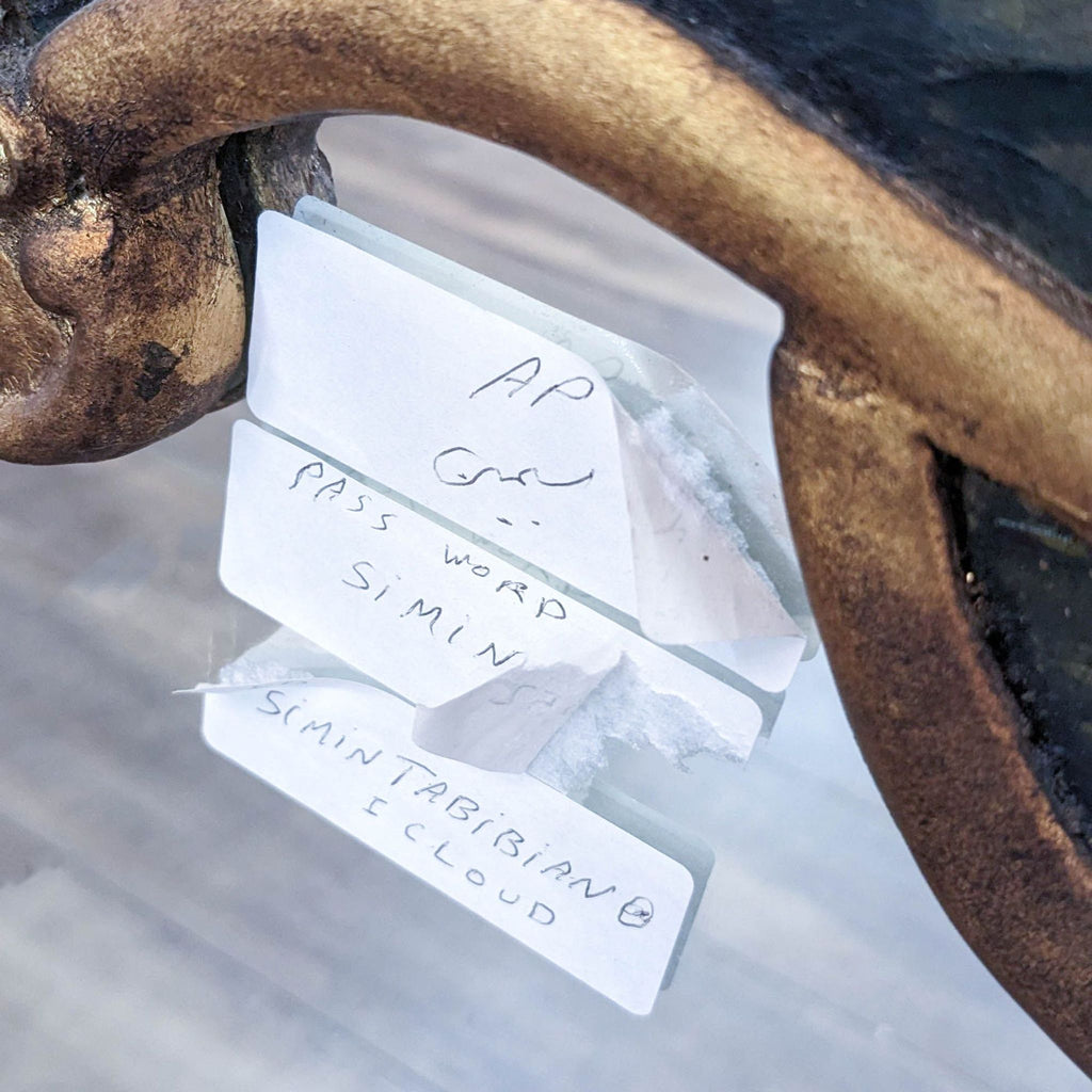 Detailed view of notes attached to the Rococo mirror’s carved design.