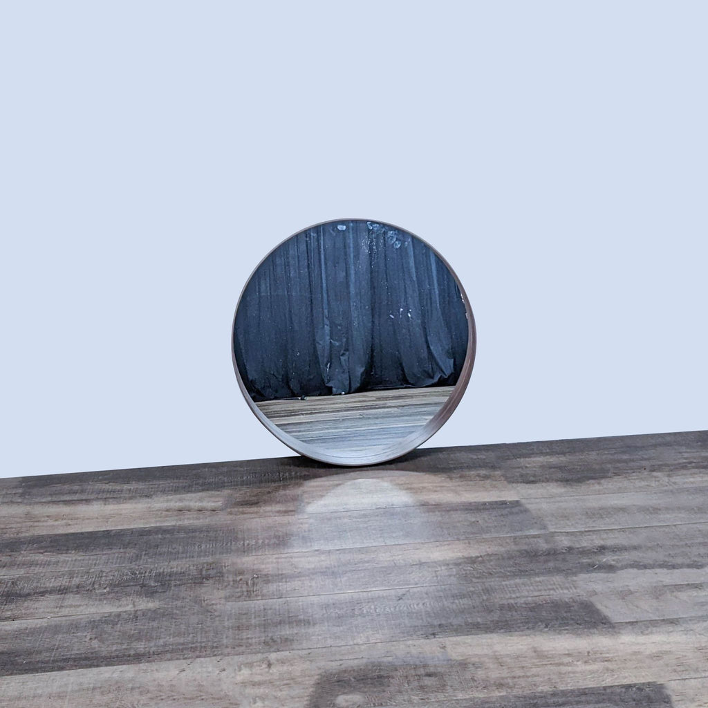 IKEA Stockholm mirror with walnut veneer frame on wooden floor.