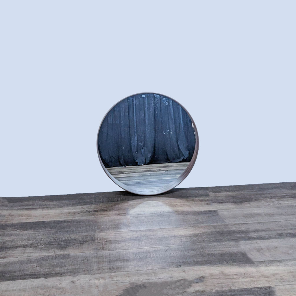 Streamlined walnut-framed IKEA mirror on a wooden surface.