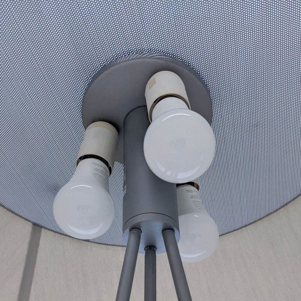 Close-up of the lamp's three bulbs set in a triangular formation.