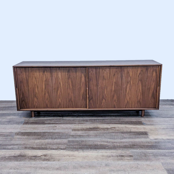 Mid-century modern walnut sideboard with closed doors and sleek design.