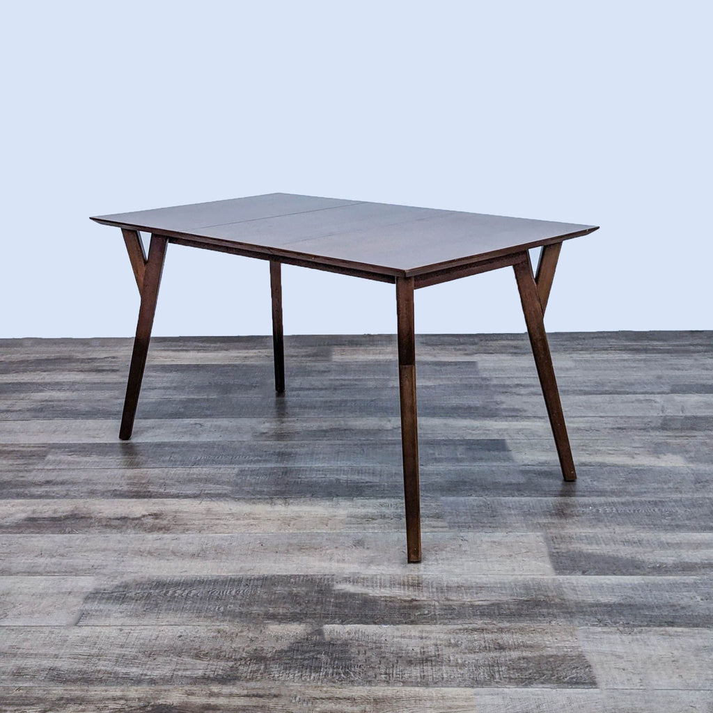 Side view of the expandable dining table by Reperch showcasing its beveled edges.