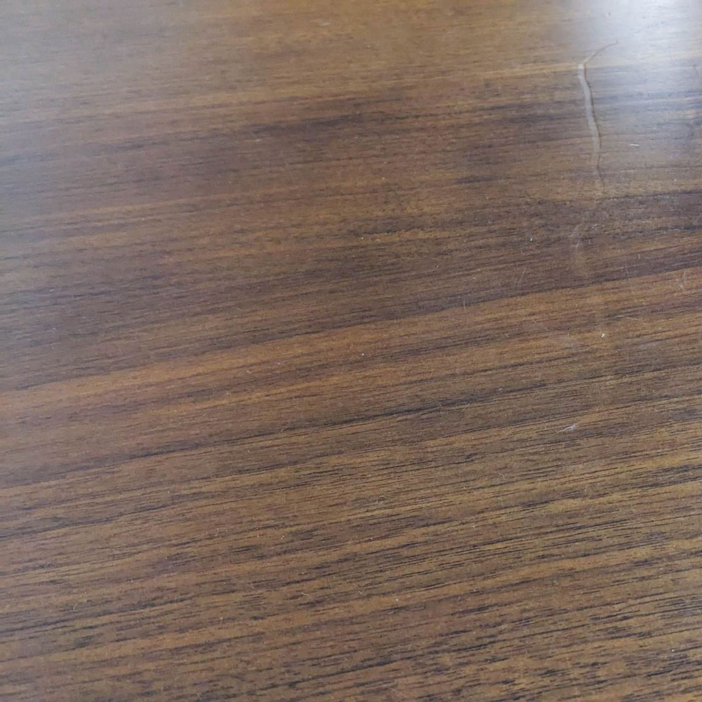 Close-up of the dining table's wood grain texture, highlighting its smooth finish.