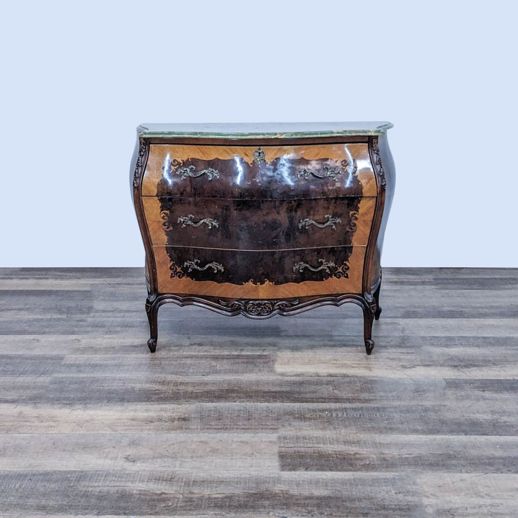 Louis XV style chest with wood inlays and green marble top.