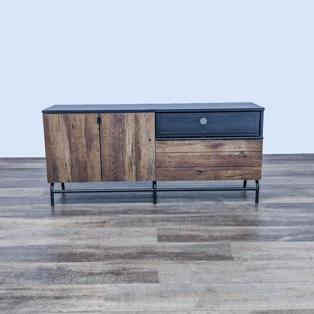 Sauder entertainment center with wood finish and black metal frame.
