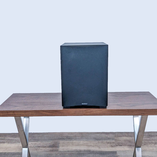 Front view of a Martin Logan subwoofer on a wooden table.  
