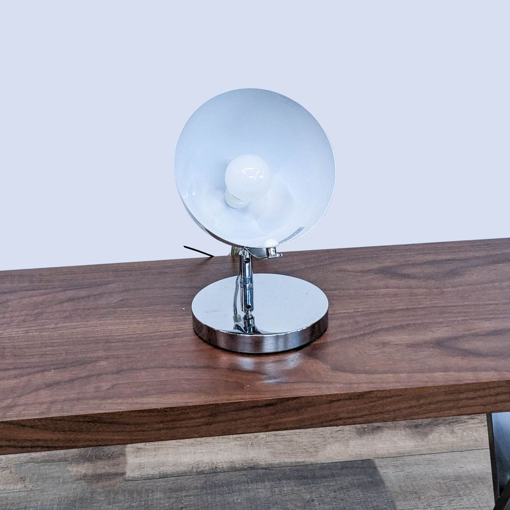 Front view of a metallic spotlight showing bulb and base.