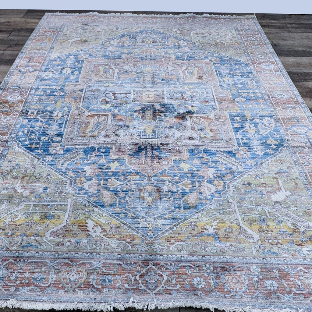 Vintage medallion rug with fringe and traditional design on wooden floor.